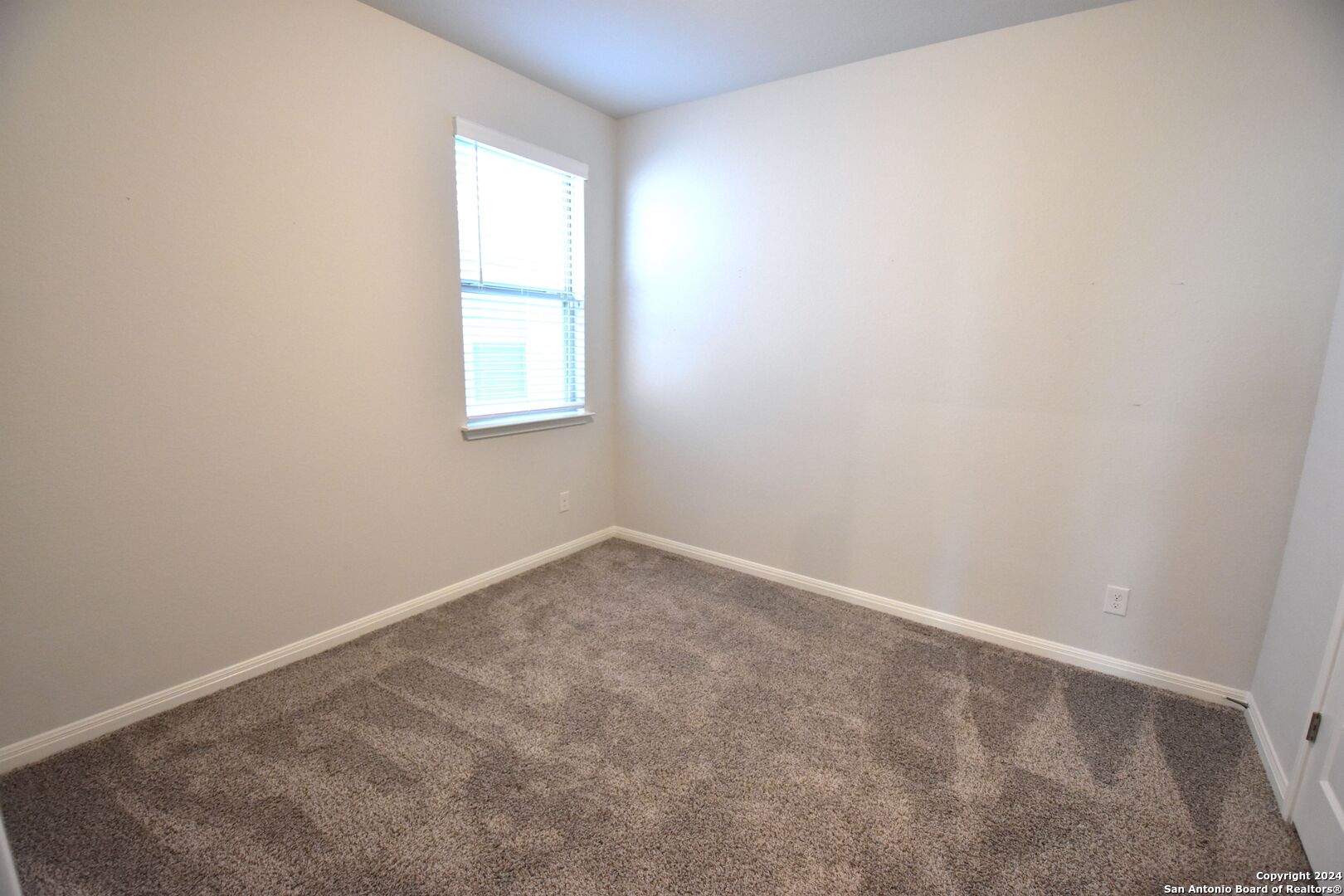 4923 Ranahan Pass St. Hedwig, TX 78152 - Photo 22 of 29 an empty room with a window