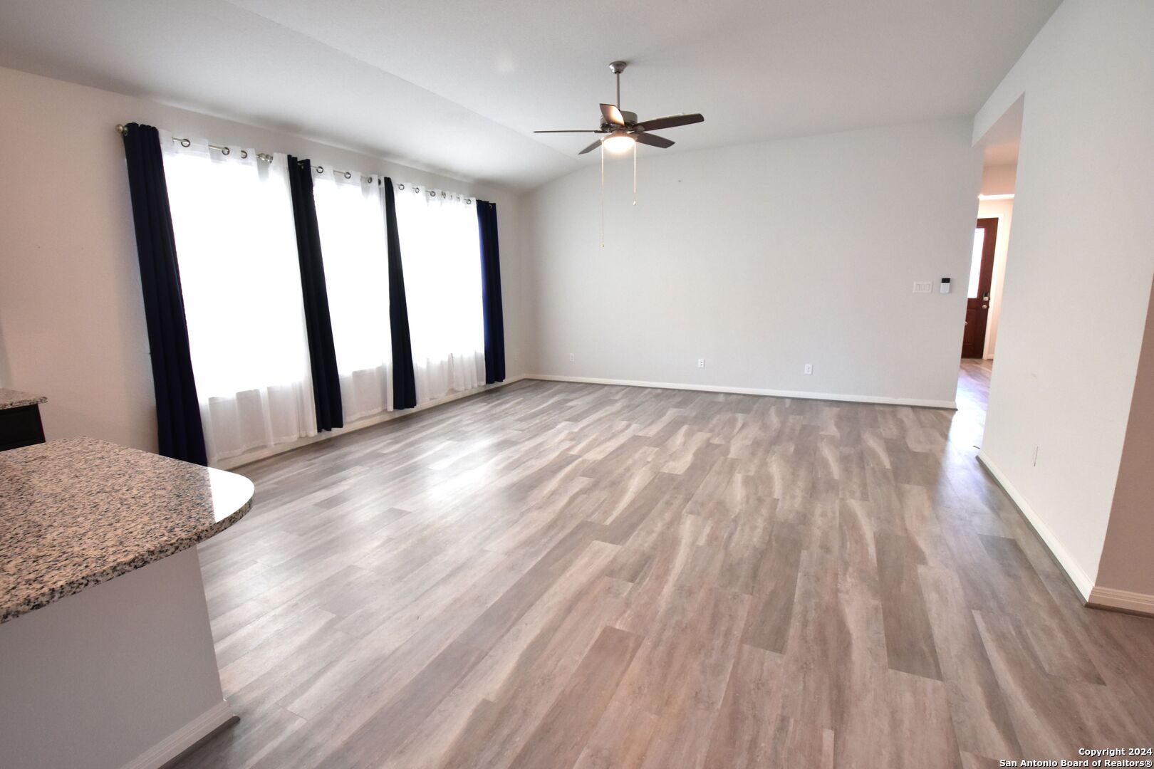 4923 Ranahan Pass St. Hedwig, TX 78152 - Photo 5 of 29 a view of a livingroom with wooden floor and a window