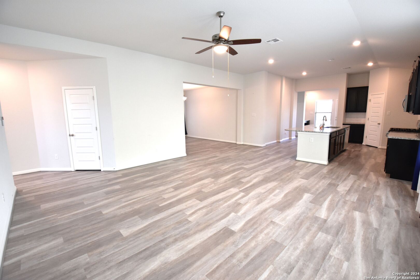 4923 Ranahan Pass St. Hedwig, TX 78152 - Photo 10 of 29 a view of a kitchen with furniture and a ceiling fan