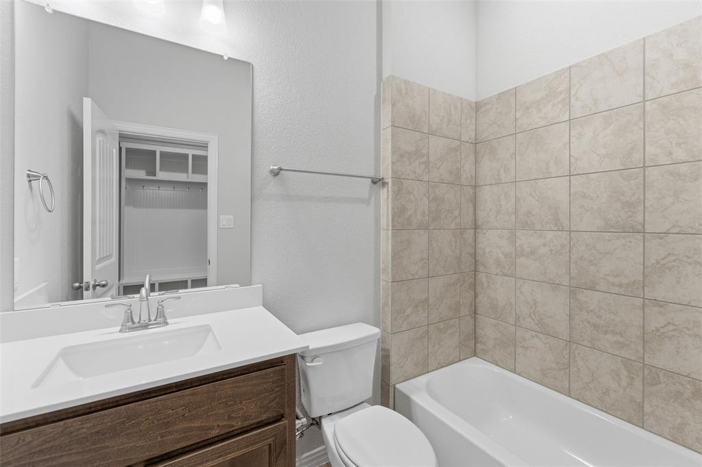 428 Guadalupe Lane Springtown, TX 76082 - Photo 15 of 29 a bathroom with a sink toilet a mirror and shower
