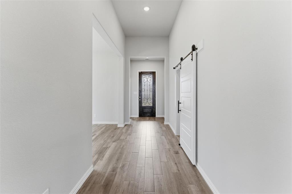 428 Guadalupe Lane Springtown, TX 76082 - Photo 20 of 29 a view of a hallway with wooden floor