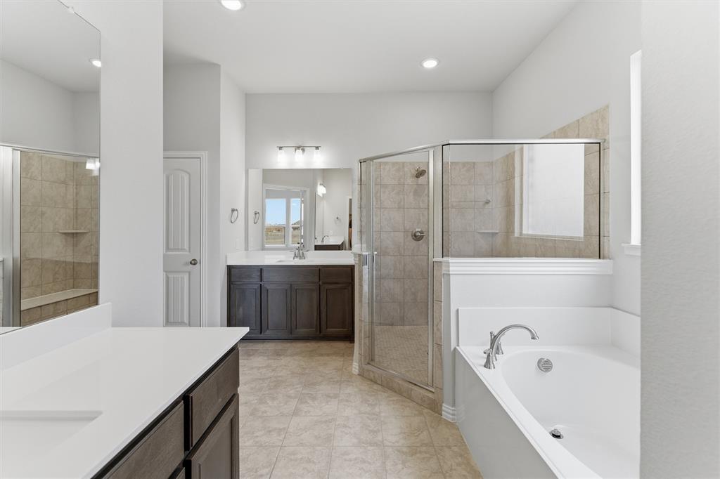 428 Guadalupe Lane Springtown, TX 76082 - Photo 27 of 29 a bathroom with a tub a sink shower and mirror
