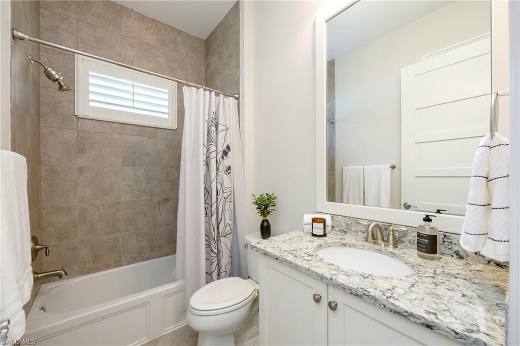 6466 Warwick Avenue Naples, FL 34113 - Photo 16 of 43 a bathroom with a granite countertop sink toilet and shower