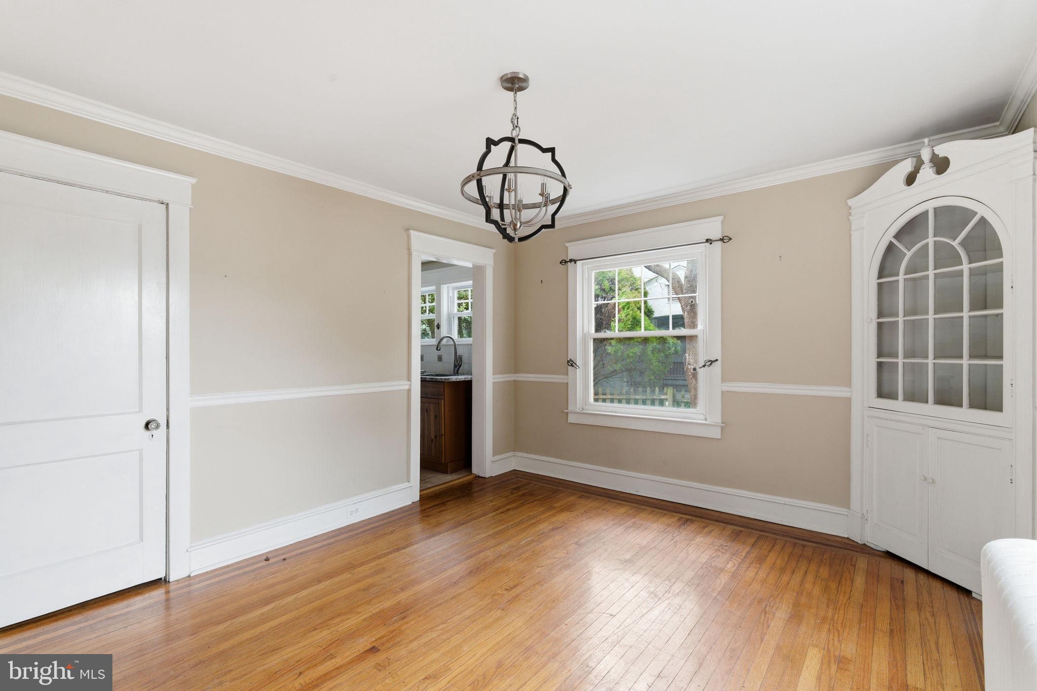 530 East Manoa Road Havertown, PA 19083 - Photo 4 of 18 an empty room with wooden floor fan and windows