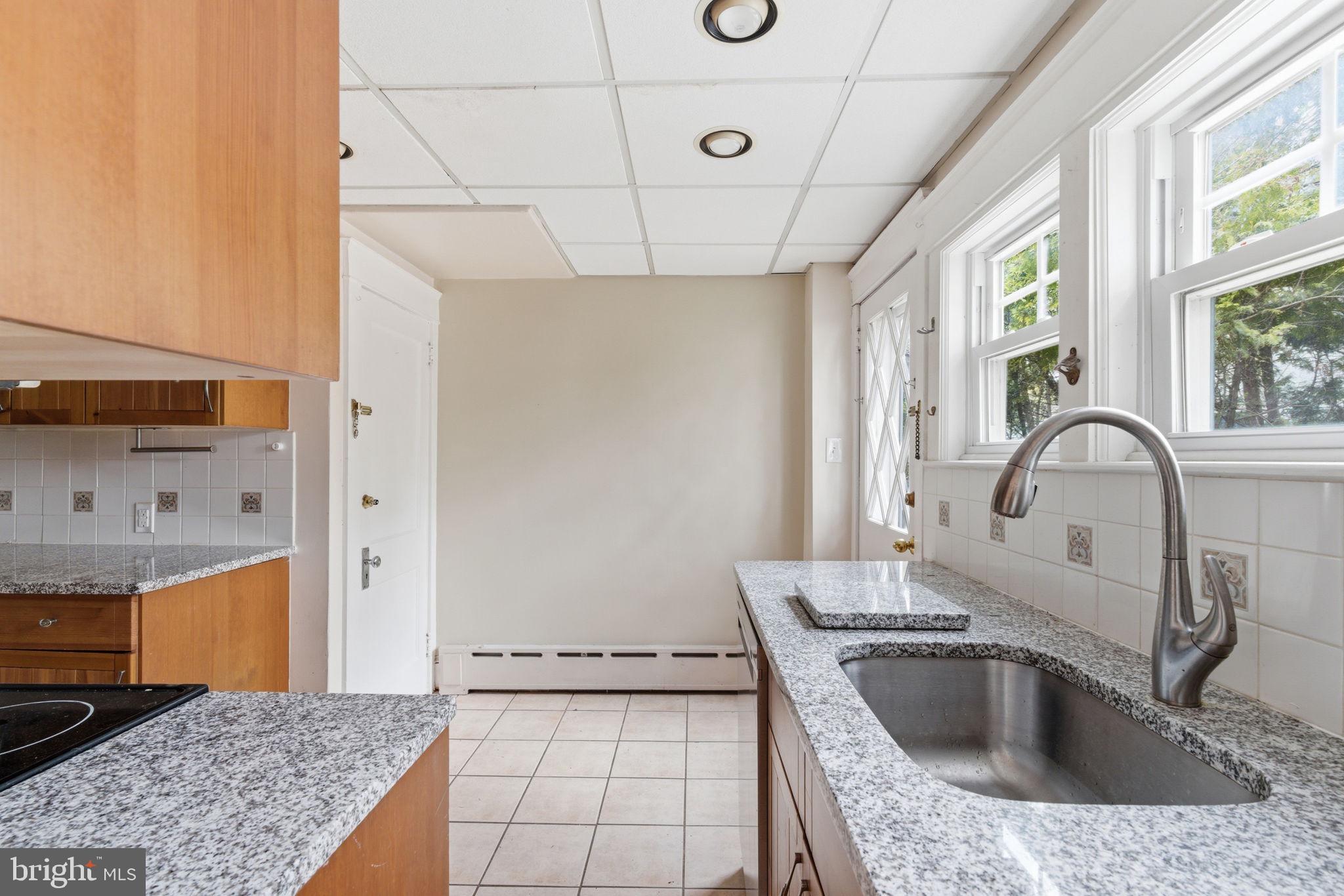 530 East Manoa Road Havertown, PA 19083 - Photo 8 of 18 a kitchen with stainless steel appliances granite countertop a sink a stove and a refrigerator