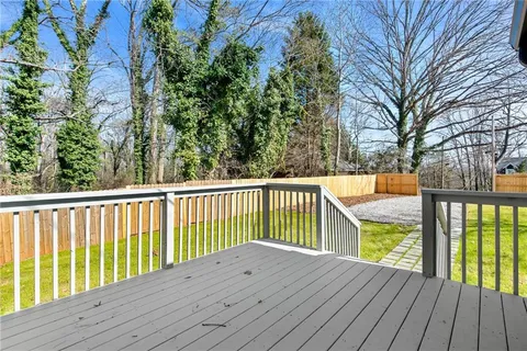 a view of balcony with wooden floor and fence