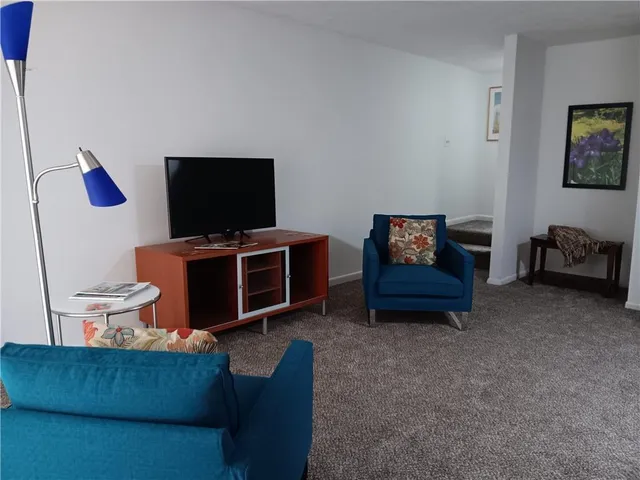 a view of a bedroom with bed and furniture