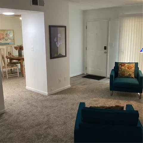 a kitchen with a refrigerator sink and cabinets