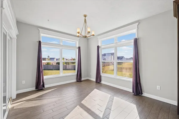a kitchen with granite countertop a stove top oven microwave and cabinets