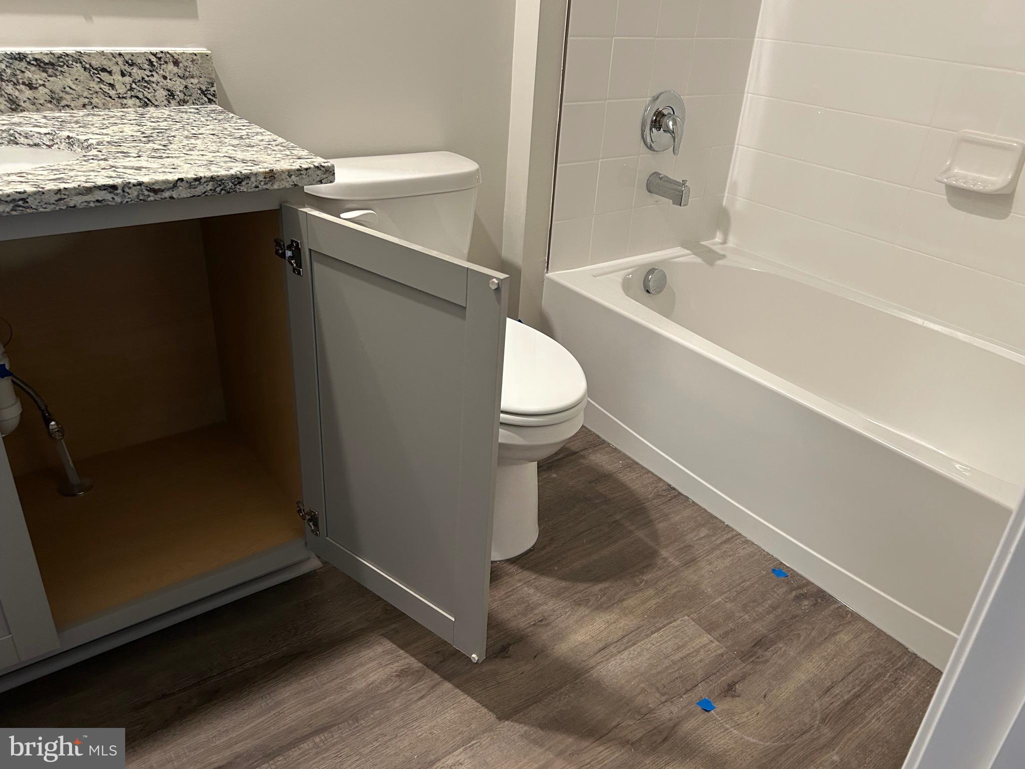 167 Rae Court Luray, VA 22835 - Photo 14 of 27 a bathroom with a granite countertop sink a toilet and bathtub