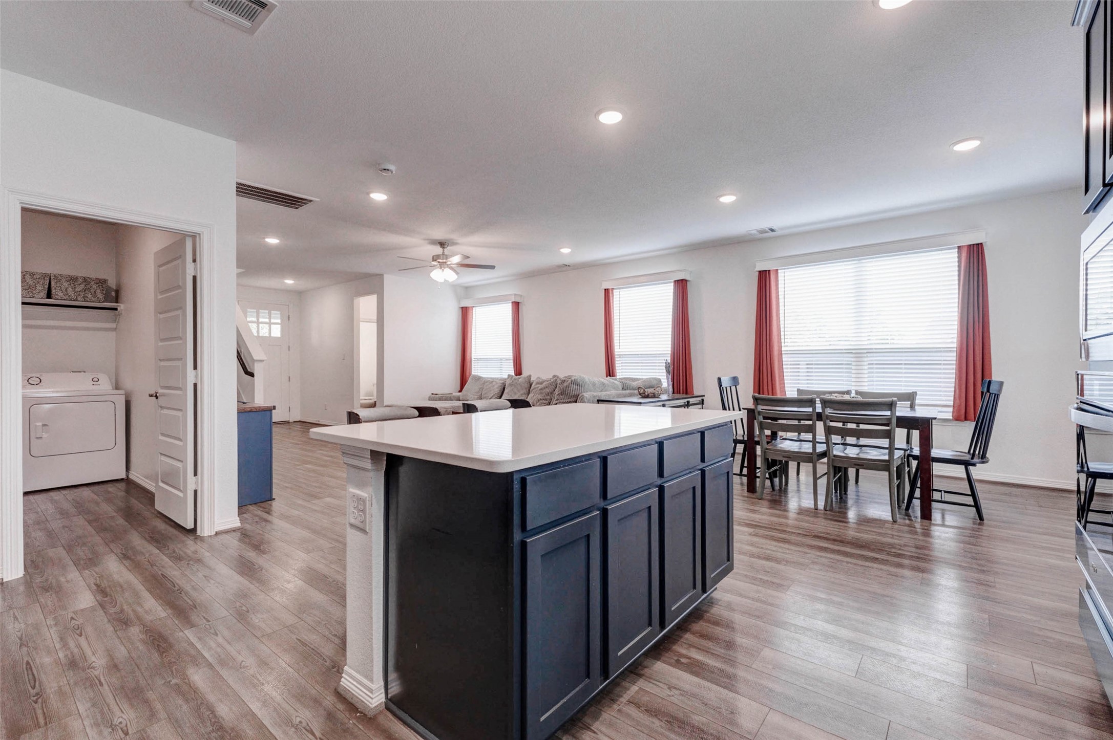 32418 Fly Fish Way Fulshear, TX 77441 - Photo 11 of 40 The oversized island offers abundant counter space and easily accommodates barstools, making it the perfect gathering spot for family and guests while meals are being prepared. This vantage point also captures the seamless flow between the kitchen, dining area, and living room, truly showcasing the home's open concept design at its best.