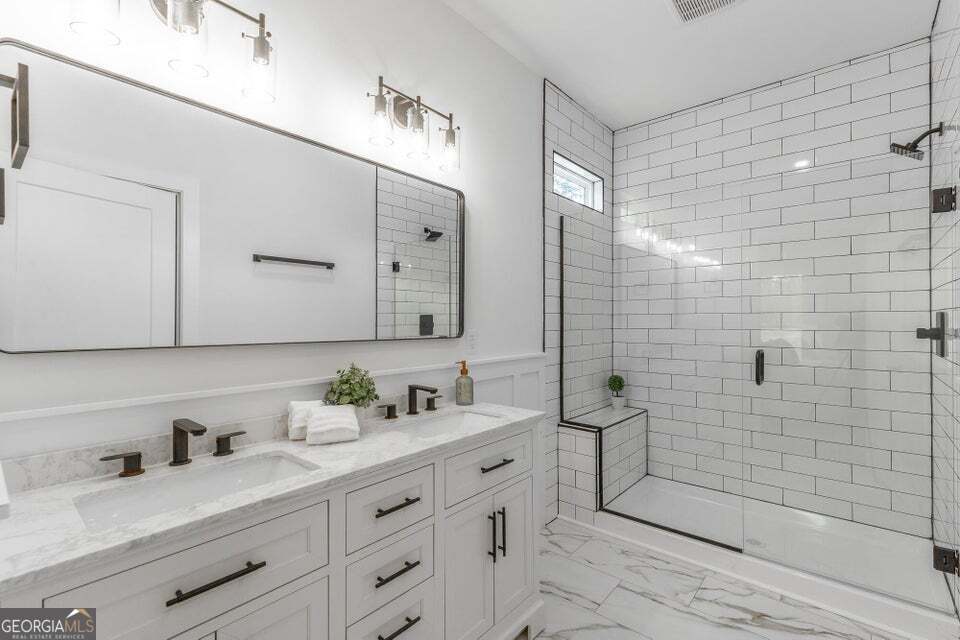 282 Glade Road Rossville, GA 30741 - Photo 18 of 20 a bathroom with a double vanity sink toilet and shower