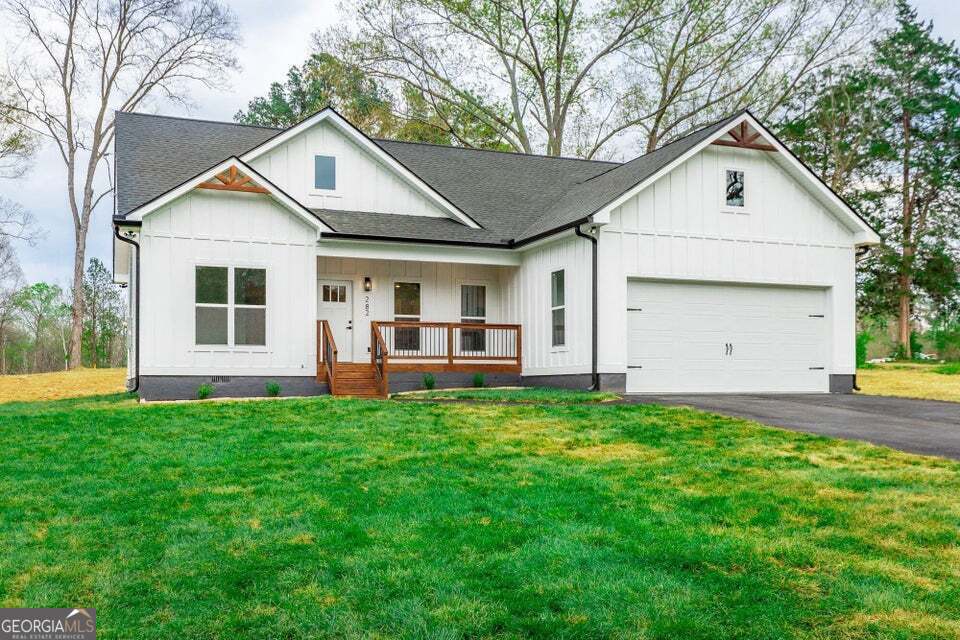 282 Glade Road Rossville, GA 30741 - Photo 2 of 20 a view of a yard in front of a house with large windows