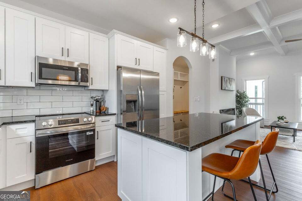 282 Glade Road Rossville, GA 30741 - Photo 10 of 20 a kitchen with stainless steel appliances granite countertop a stove a sink and a refrigerator
