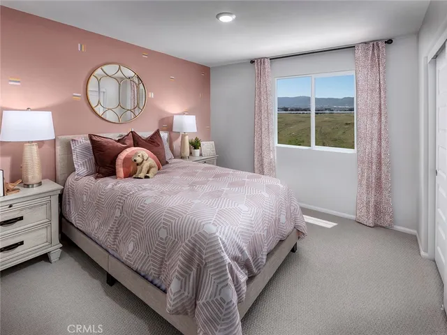 a bedroom with a bed and a large window