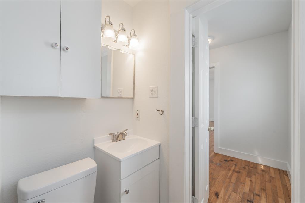 1509 Park Pl Avenue, Unit A Fort Worth, TX 76110 - Photo 12 of 13 a bathroom with a toilet sink and mirror