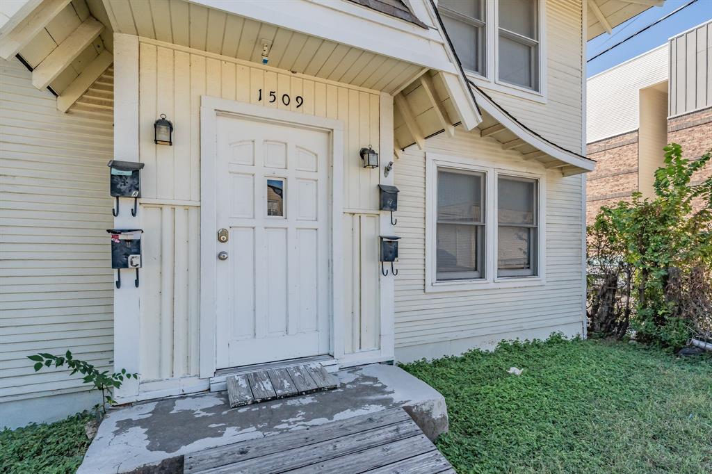 1509 Park Pl Avenue, Unit A Fort Worth, TX 76110 - Photo 2 of 13 a view of a brick house with a small yard