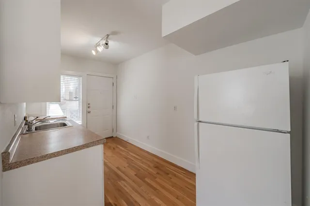a kitchen with a refrigerator and a stove