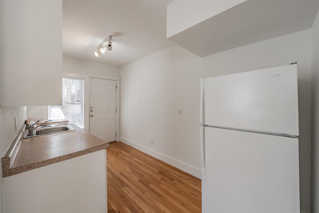 1509 Park Pl Avenue, Unit A Fort Worth, TX 76110 - Photo 7 of 13 a kitchen with a refrigerator and a stove