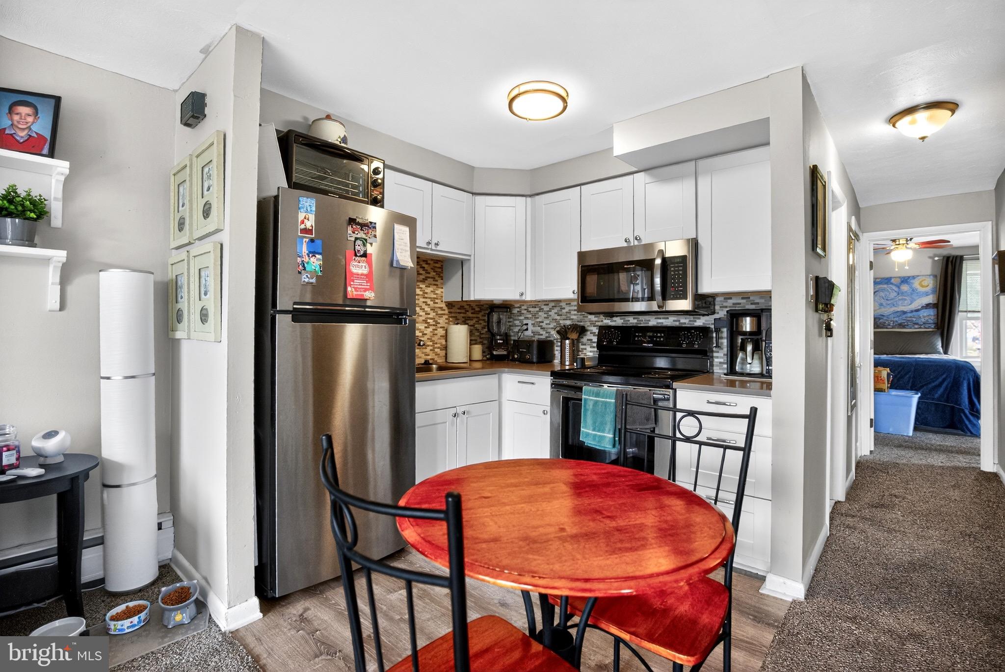 4401 Manayunk Avenue Philadelphia, PA 19128 - Photo 15 of 25 a kitchen with stainless steel appliances granite countertop a refrigerator and a stove top oven