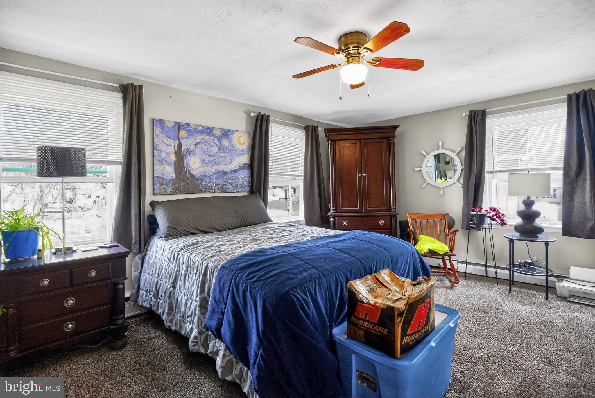 4401 Manayunk Avenue Philadelphia, PA 19128 - Photo 18 of 25 a bedroom with a bed and a chandelier