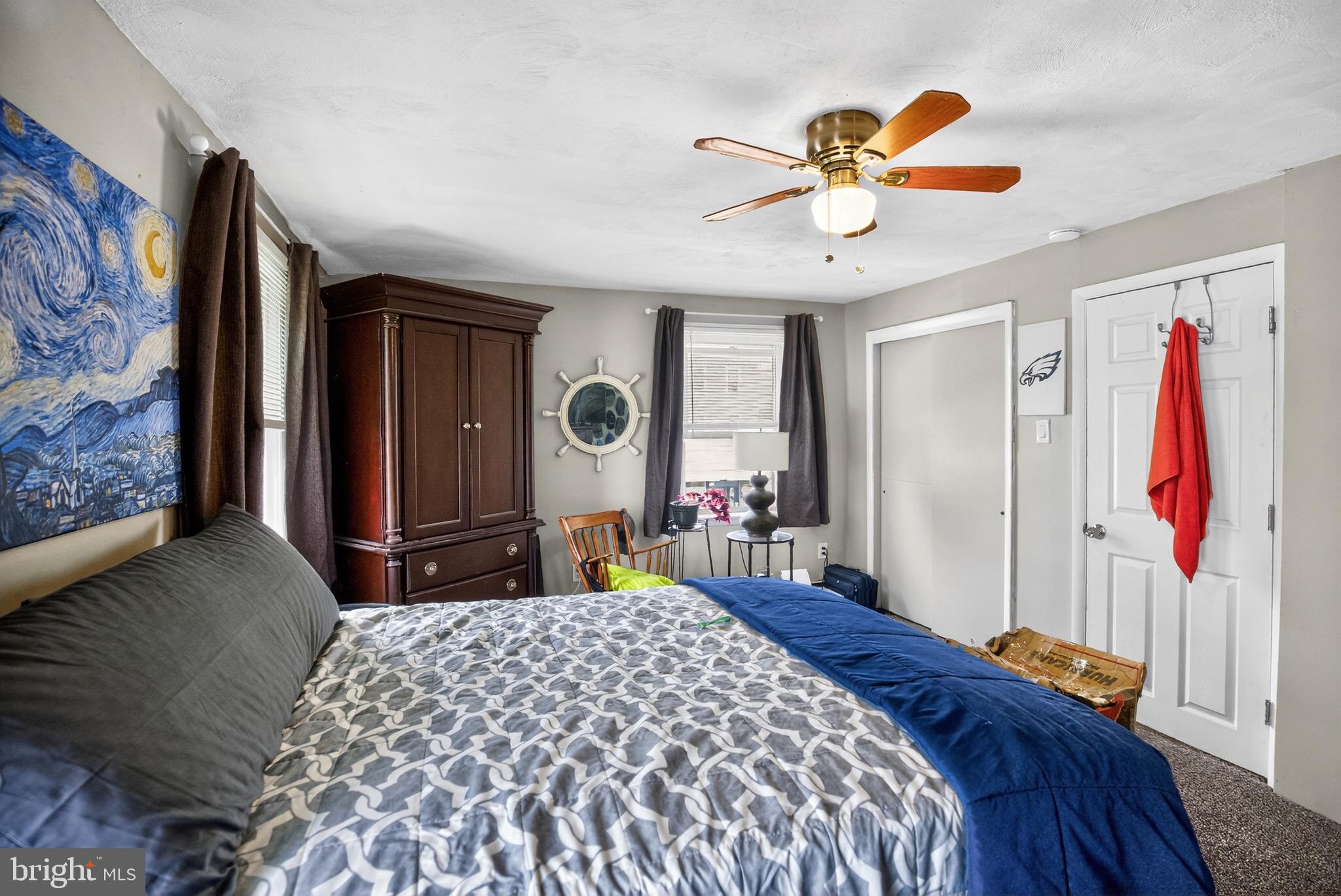 4401 Manayunk Avenue Philadelphia, PA 19128 - Photo 19 of 25 a bedroom with a bed and a chandelier