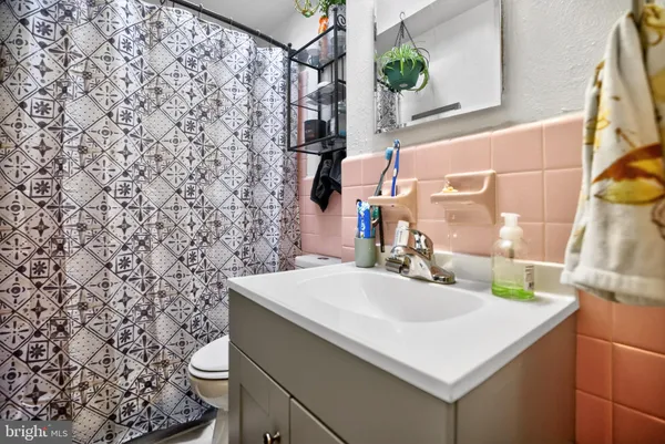 a bathroom with a sink a toilet and a mirror
