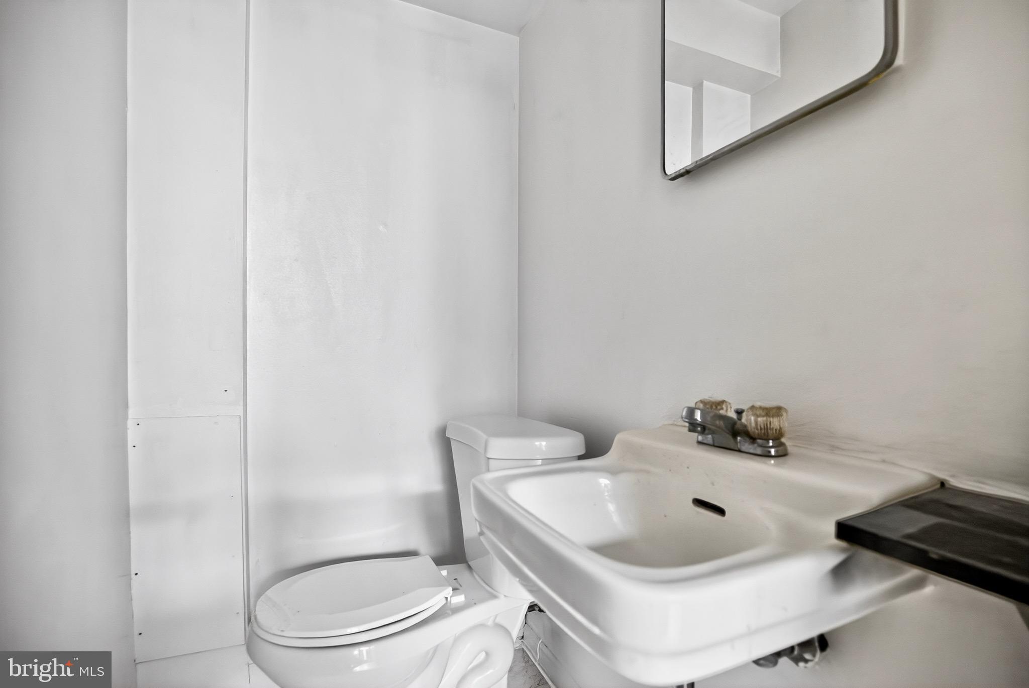 4401 Manayunk Avenue Philadelphia, PA 19128 - Photo 24 of 25 a bathroom with a sink a toilet and a mirror