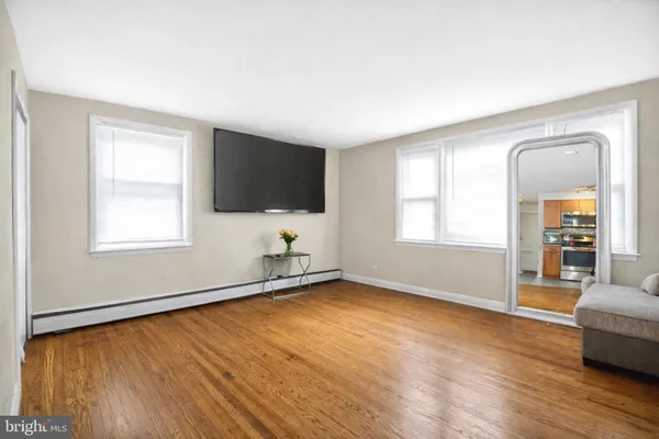 a view of a livingroom with wooden floor and a window