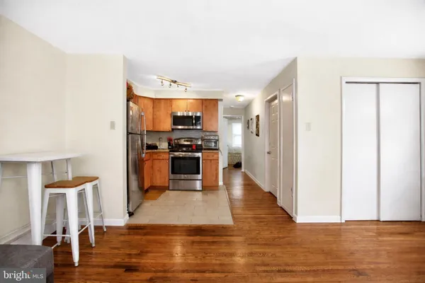 a kitchen with stainless steel appliances a refrigerator and a stove top oven