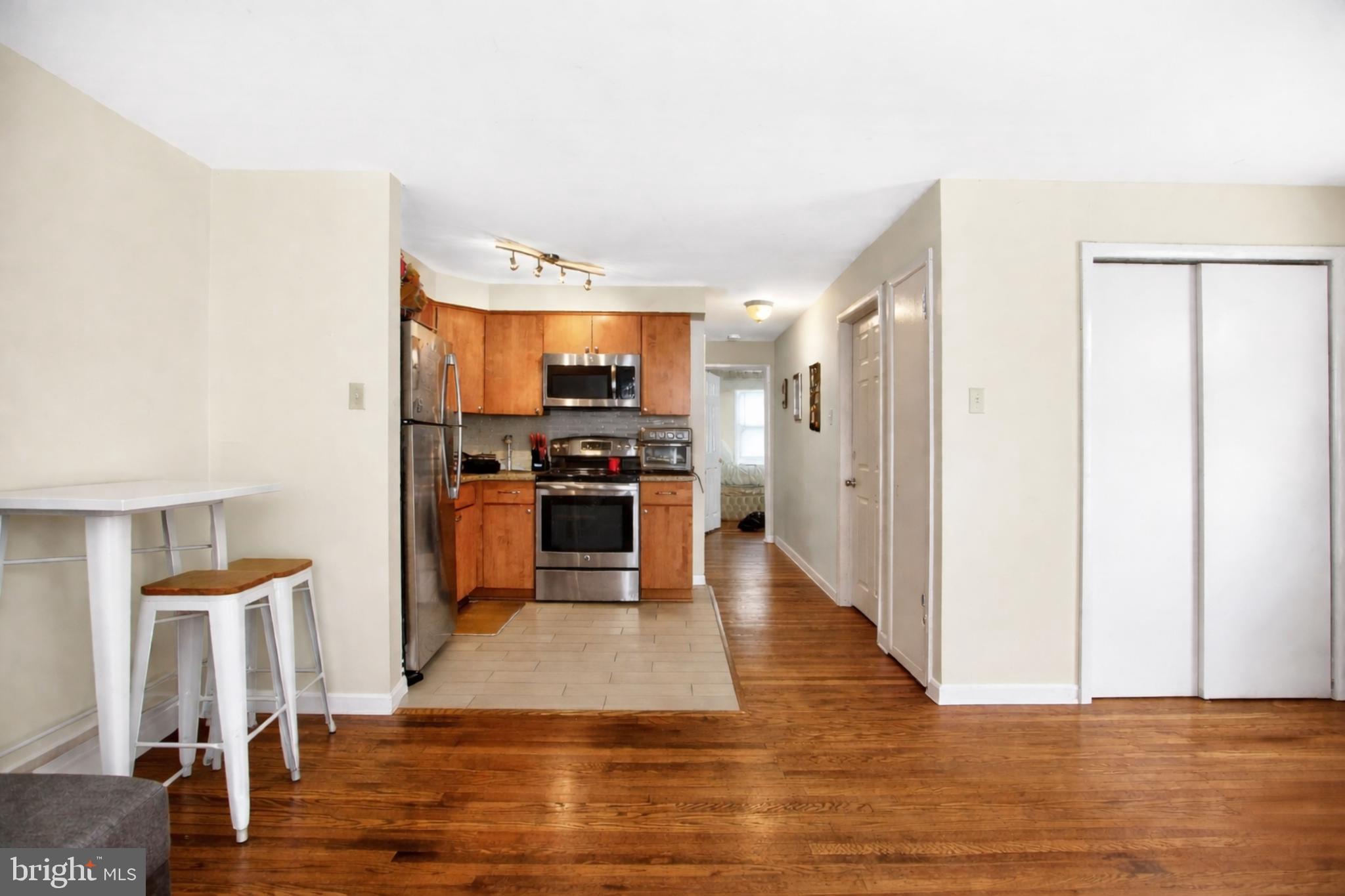 4401 Manayunk Avenue Philadelphia, PA 19128 - Photo 7 of 25 a kitchen with stainless steel appliances a refrigerator and a stove top oven