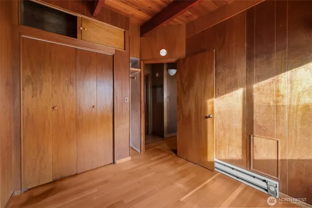 a view of a room with wooden floor and windows
