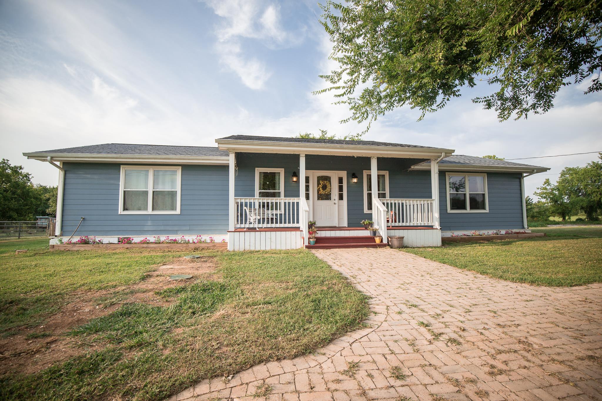 420 Squire Hall Road Bell Buckle, TN 37020 - Photo 23 of 23 a front view of a house with a garden and patio