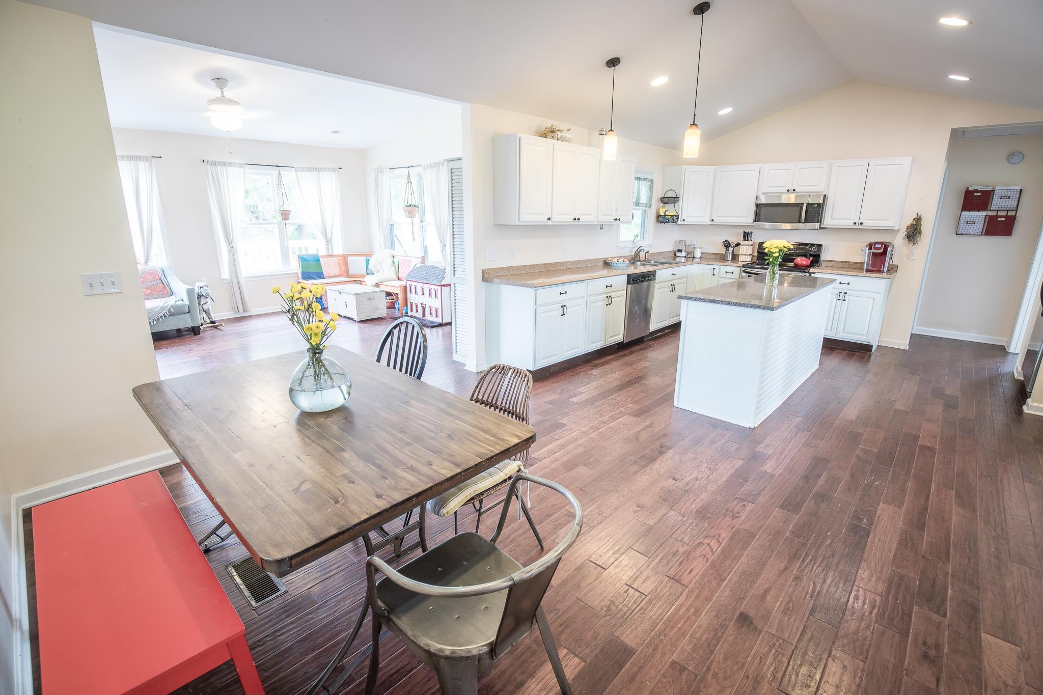 420 Squire Hall Road Bell Buckle, TN 37020 - Photo 5 of 23 a kitchen with a dining table chairs stove refrigerator and cabinets