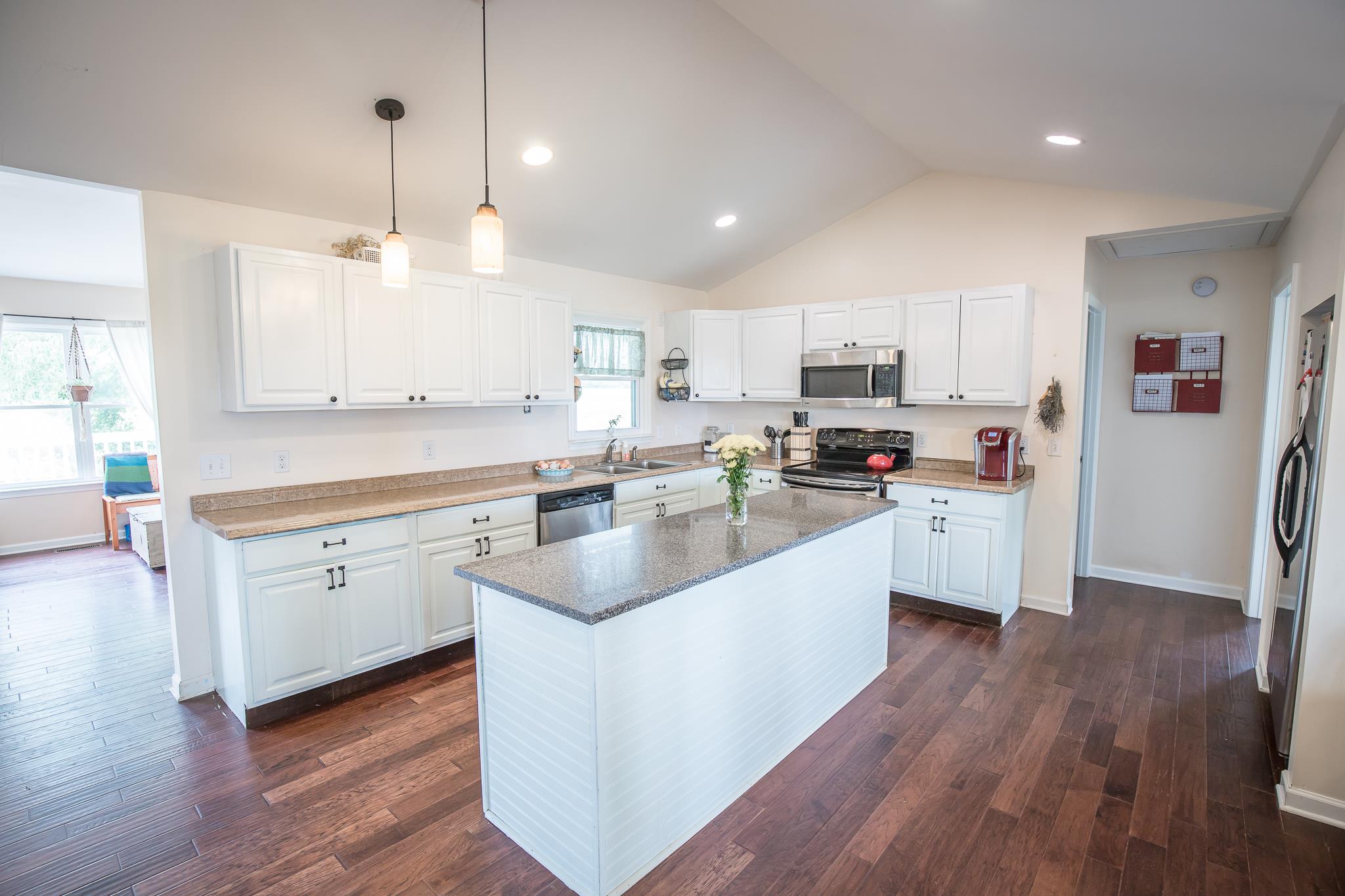 420 Squire Hall Road Bell Buckle, TN 37020 - Photo 6 of 23 a large white kitchen with lots of counter space a sink appliances and cabinets
