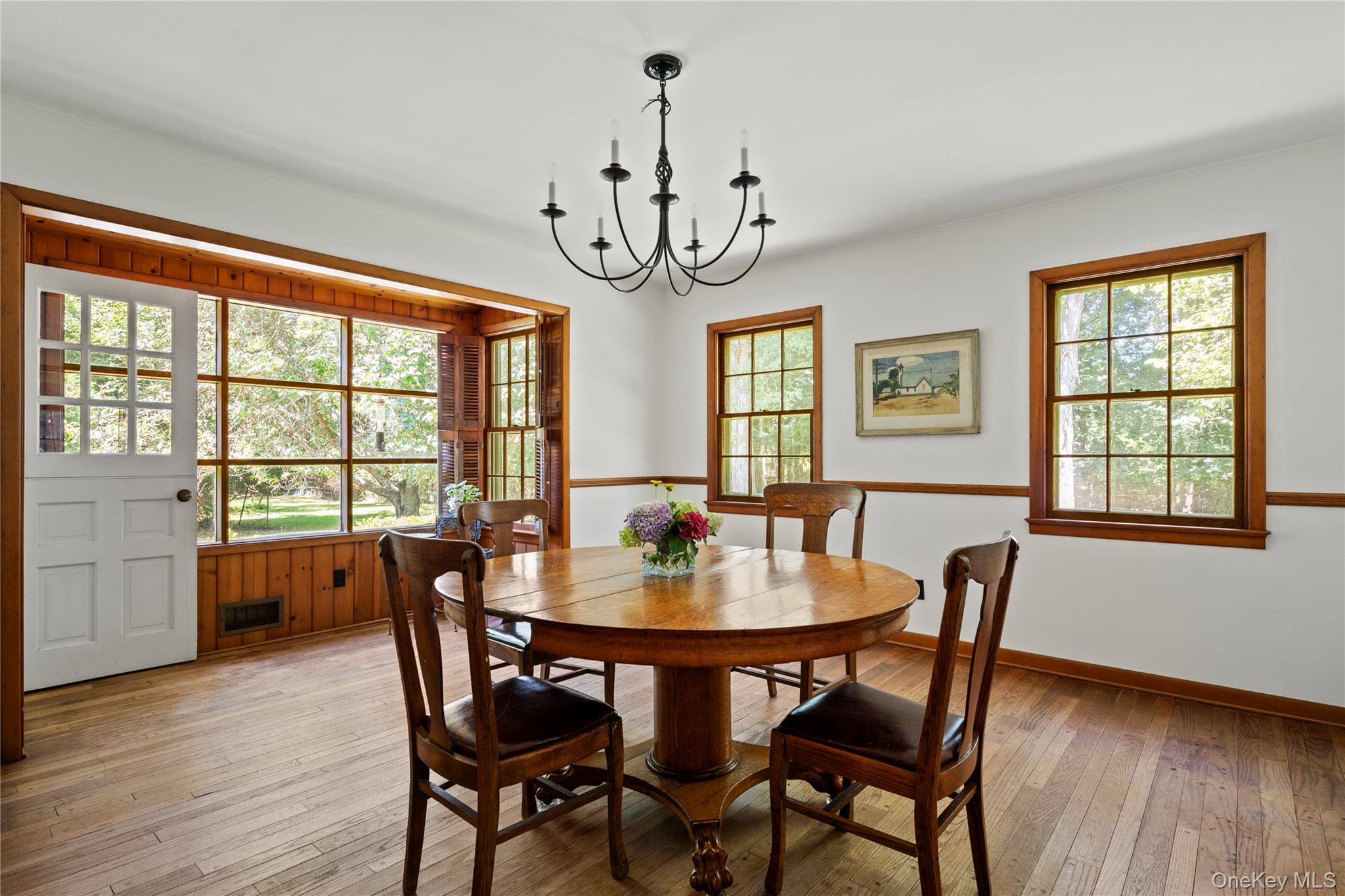26 South Menantic Road Shelter Island, NY 11964 - Photo 12 of 42 a view of a dining room with furniture window and wooden floor