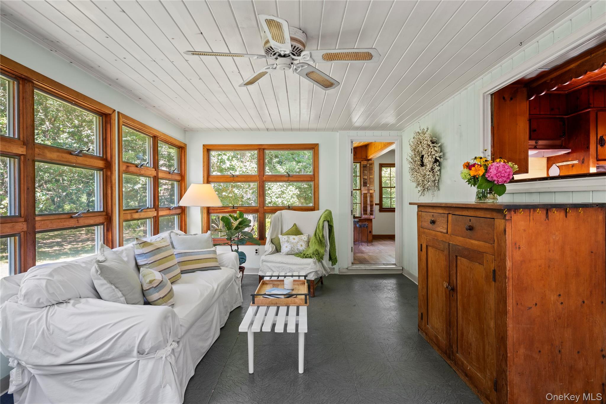 26 South Menantic Road Shelter Island, NY 11964 - Photo 23 of 49 a living room with furniture a fireplace and a chandelier