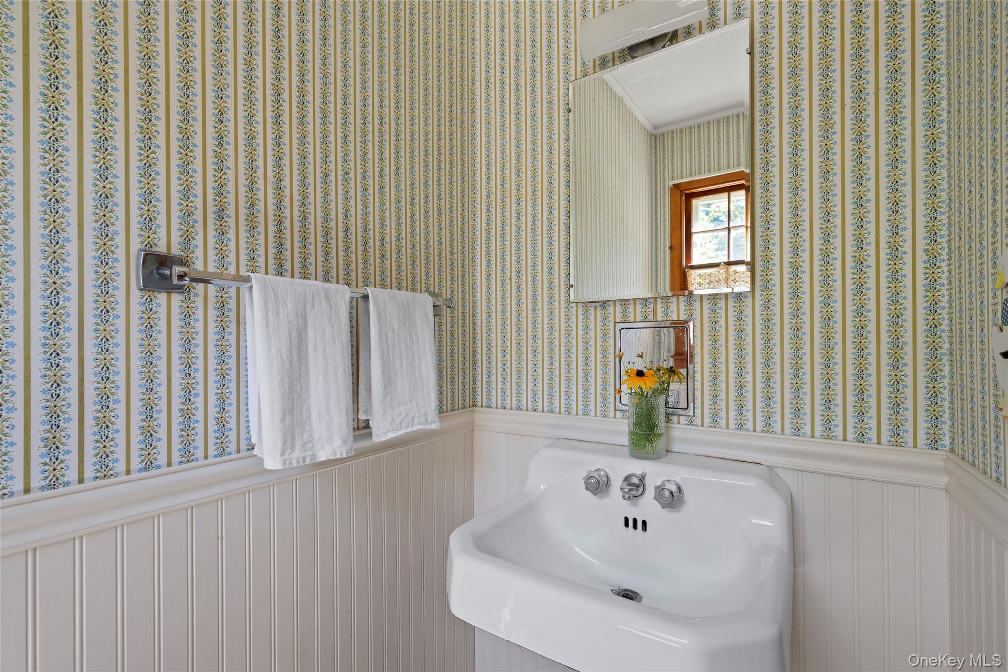 26 South Menantic Road Shelter Island, NY 11964 - Photo 23 of 42 a bathroom with a sink and a mirror