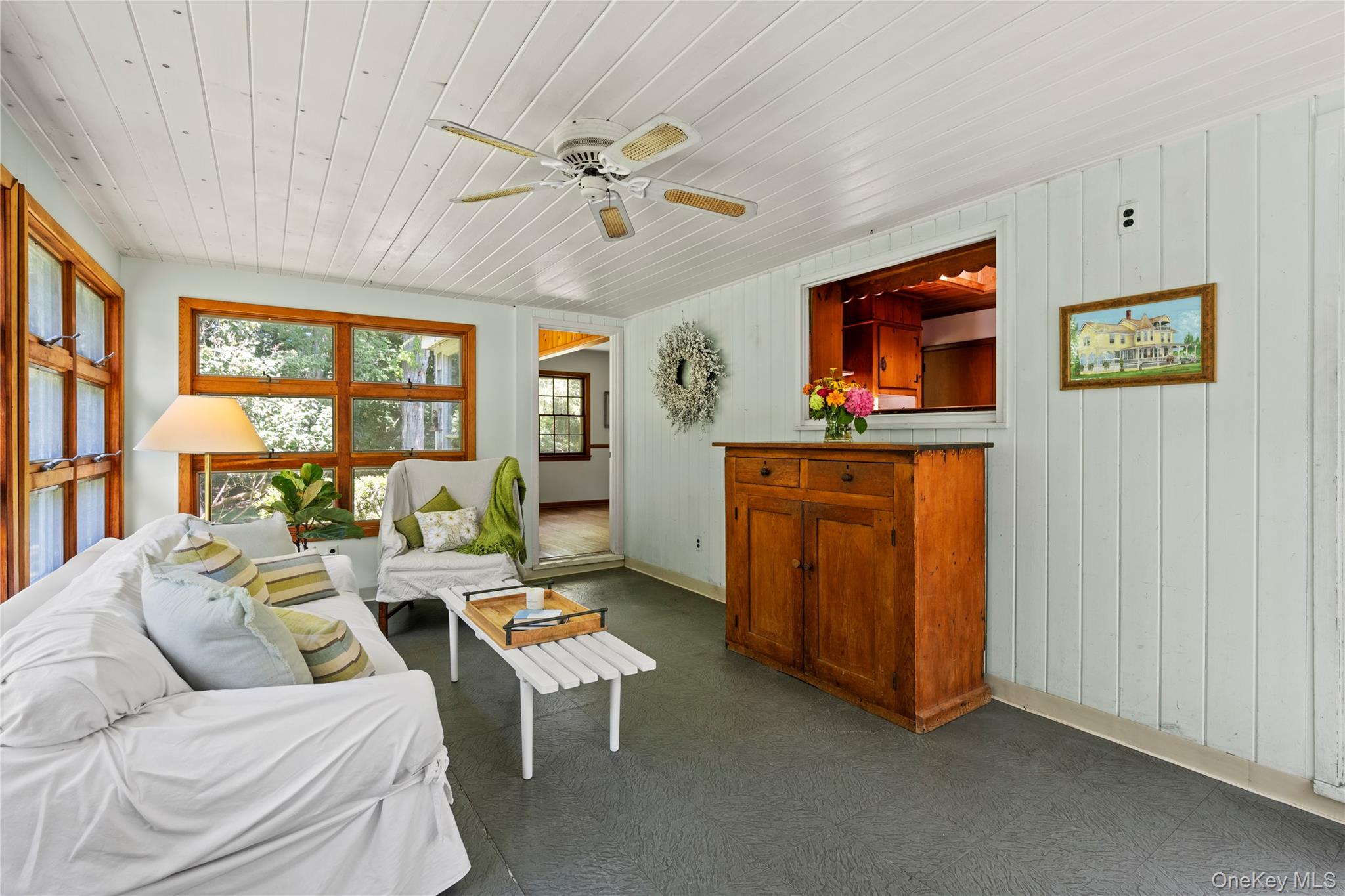 26 South Menantic Road Shelter Island, NY 11964 - Photo 24 of 49 a living room with furniture a window and a ceiling fan