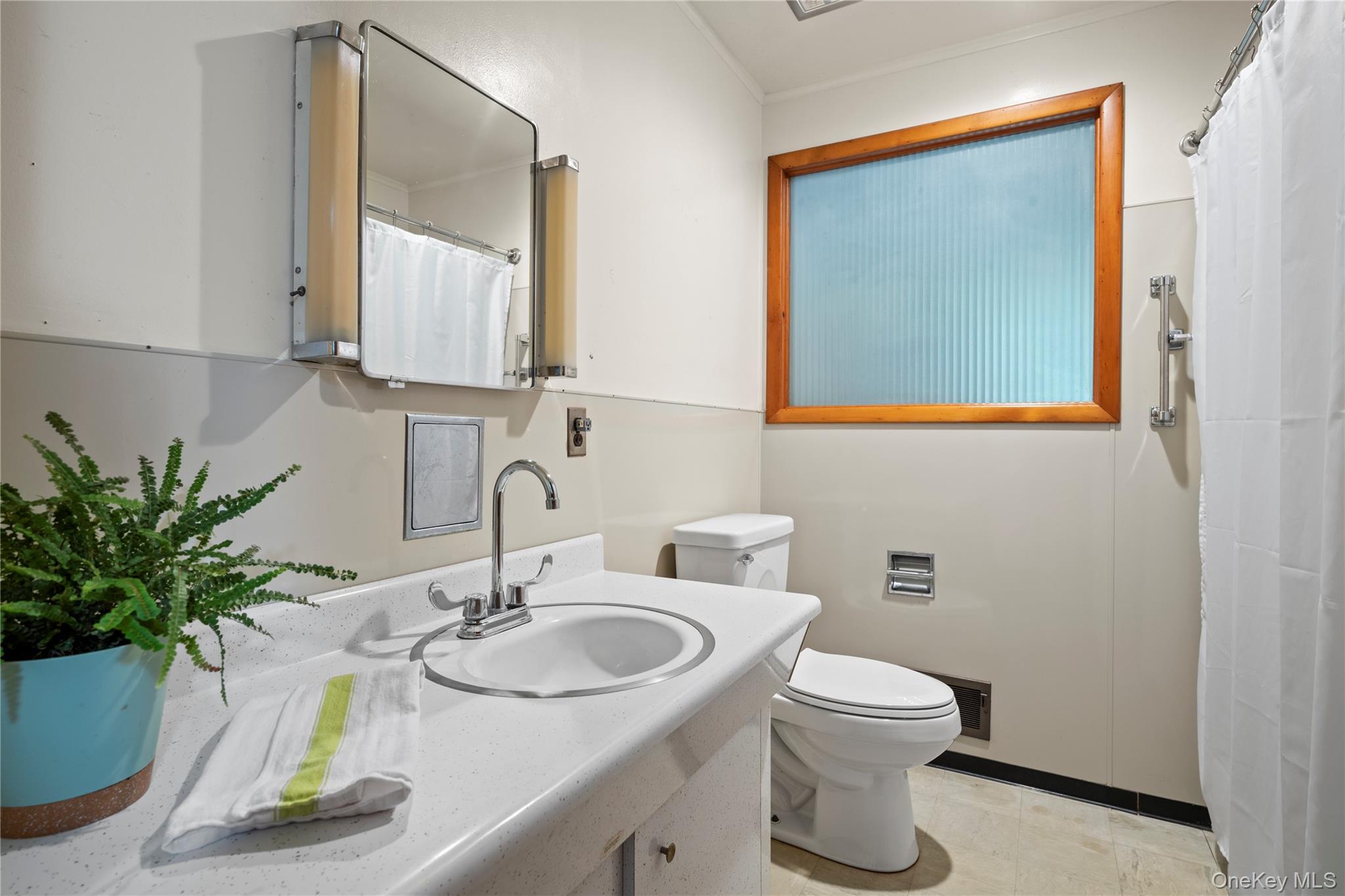 26 South Menantic Road Shelter Island, NY 11964 - Photo 25 of 42 a bathroom with a toilet a sink and mirror