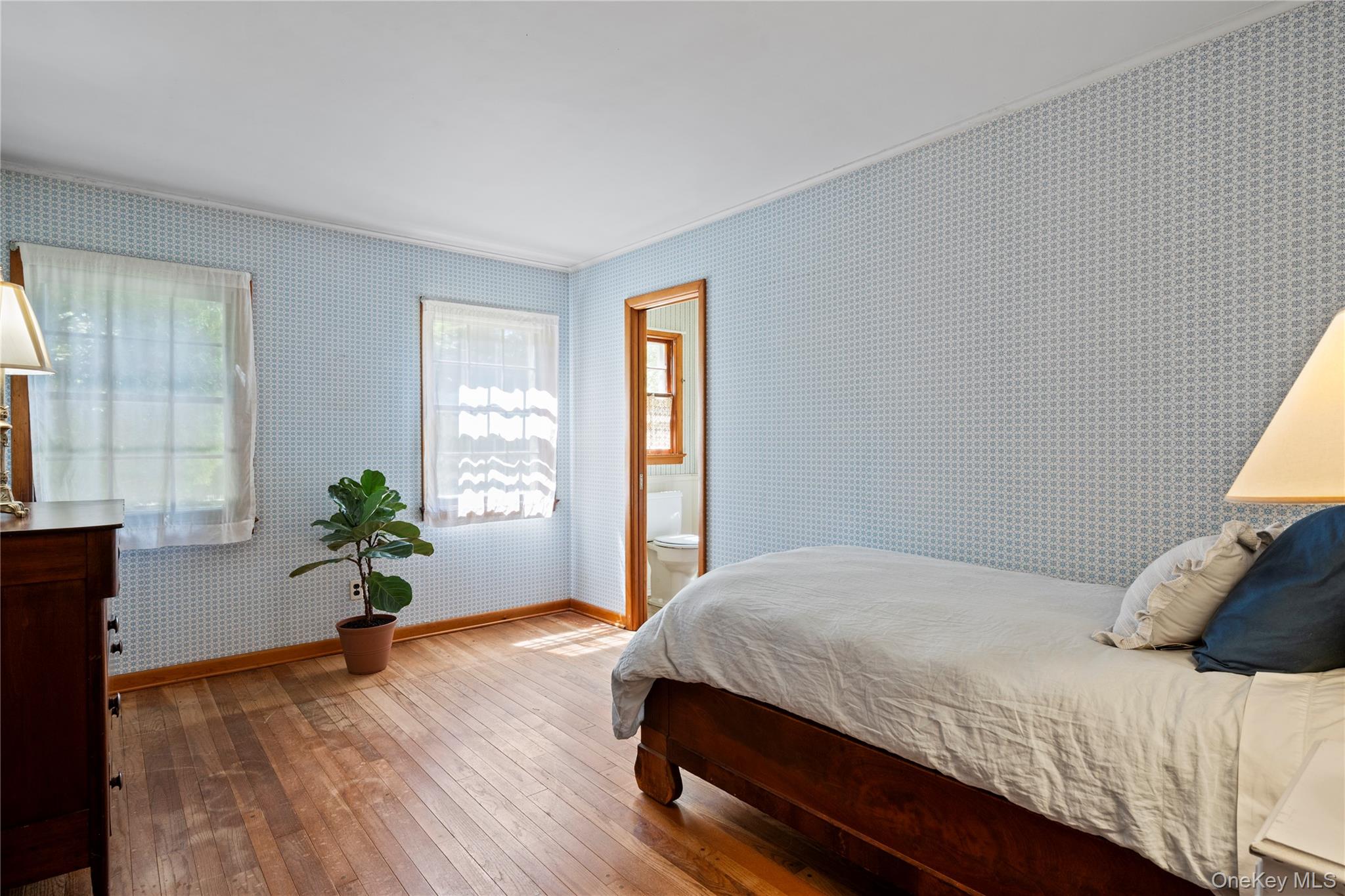 26 South Menantic Road Shelter Island, NY 11964 - Photo 26 of 49 a bedroom with a large bed and wooden floor