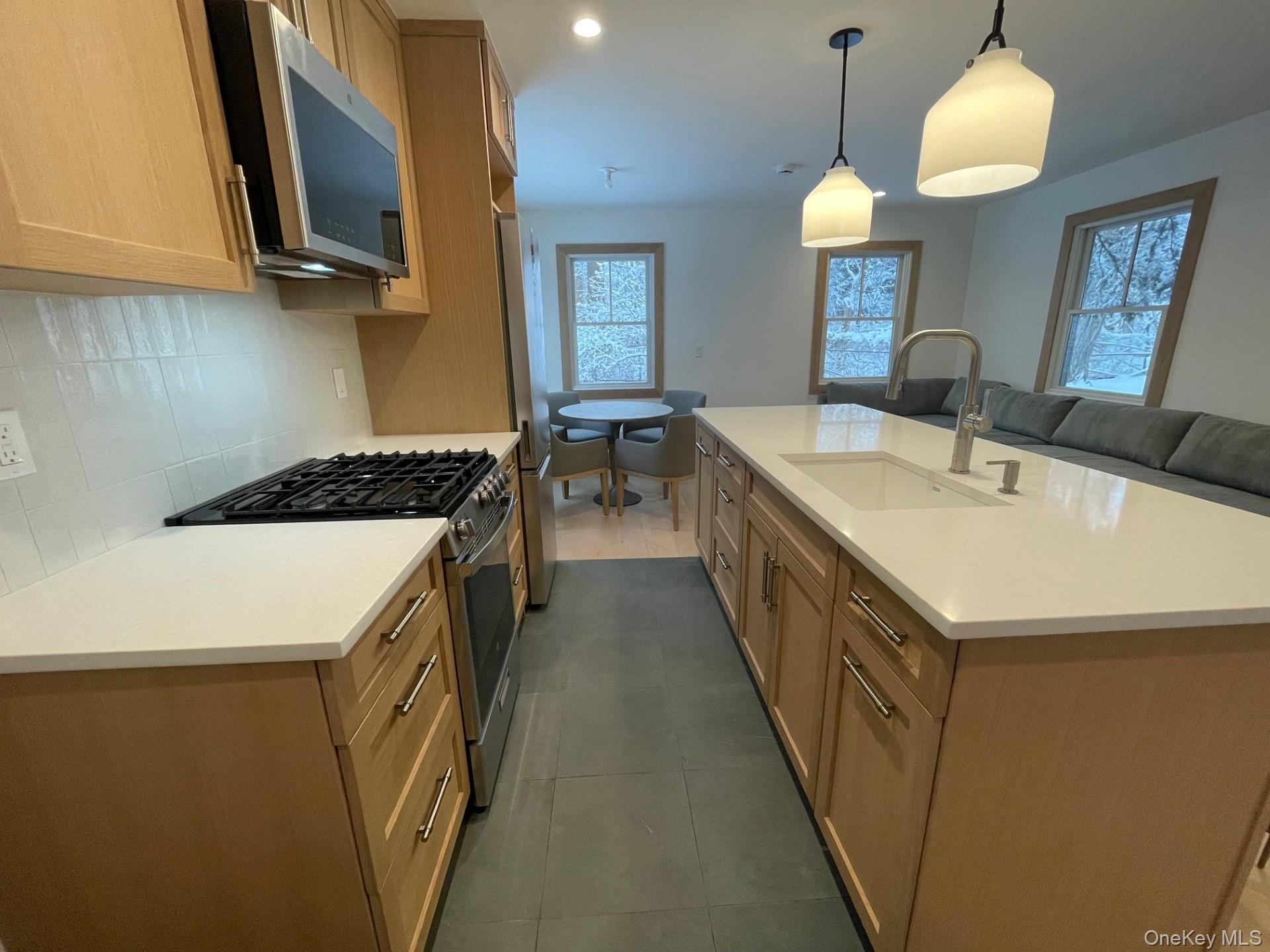 26 South Menantic Road Shelter Island, NY 11964 - Photo 3 of 49 a kitchen with a sink and a stove top oven