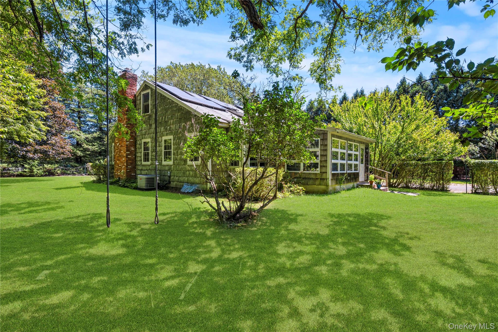 26 South Menantic Road Shelter Island, NY 11964 - Photo 34 of 49 View of side yard and looking toward archway to driveway 2 car garage
