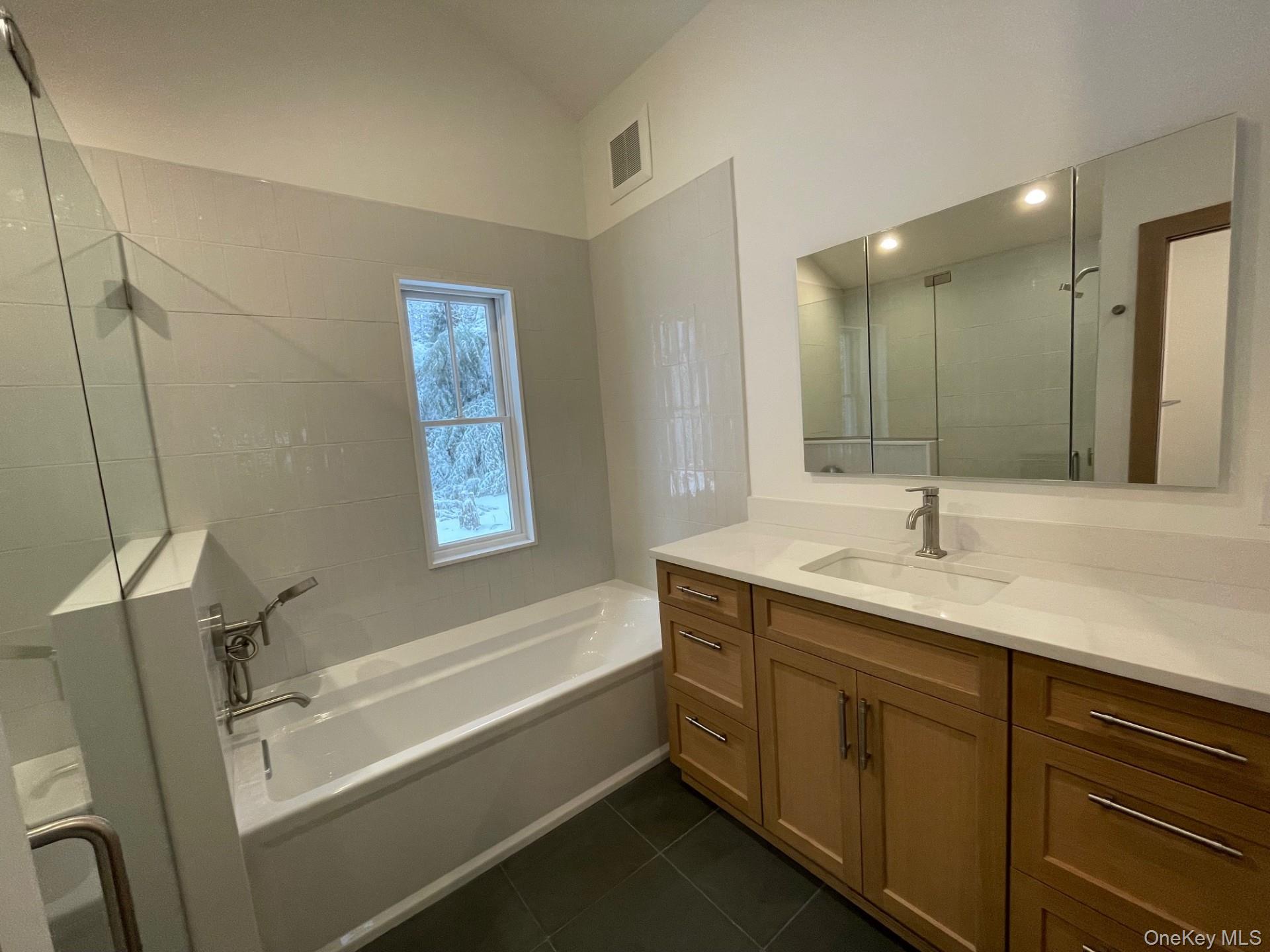 26 South Menantic Road Shelter Island, NY 11964 - Photo 4 of 49 a bathroom with a tub sink and mirror