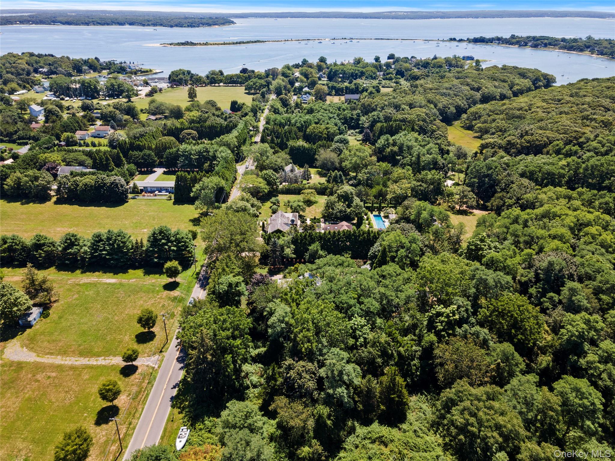 26 South Menantic Road Shelter Island, NY 11964 - Photo 42 of 49 an aerial view of a house with a yard and lake view