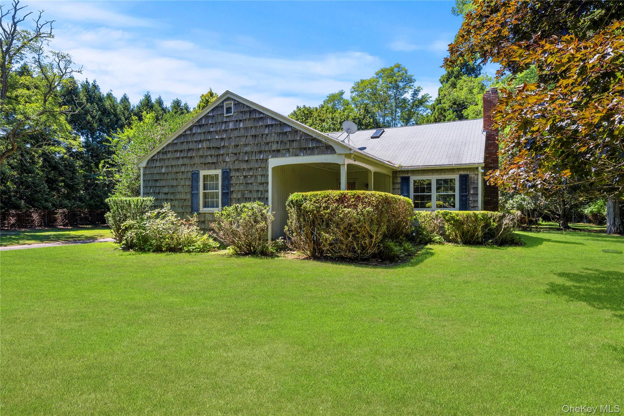 26 South Menantic Road Shelter Island, NY 11964 - Photo 10 of 49 a front view of a house with a yard
