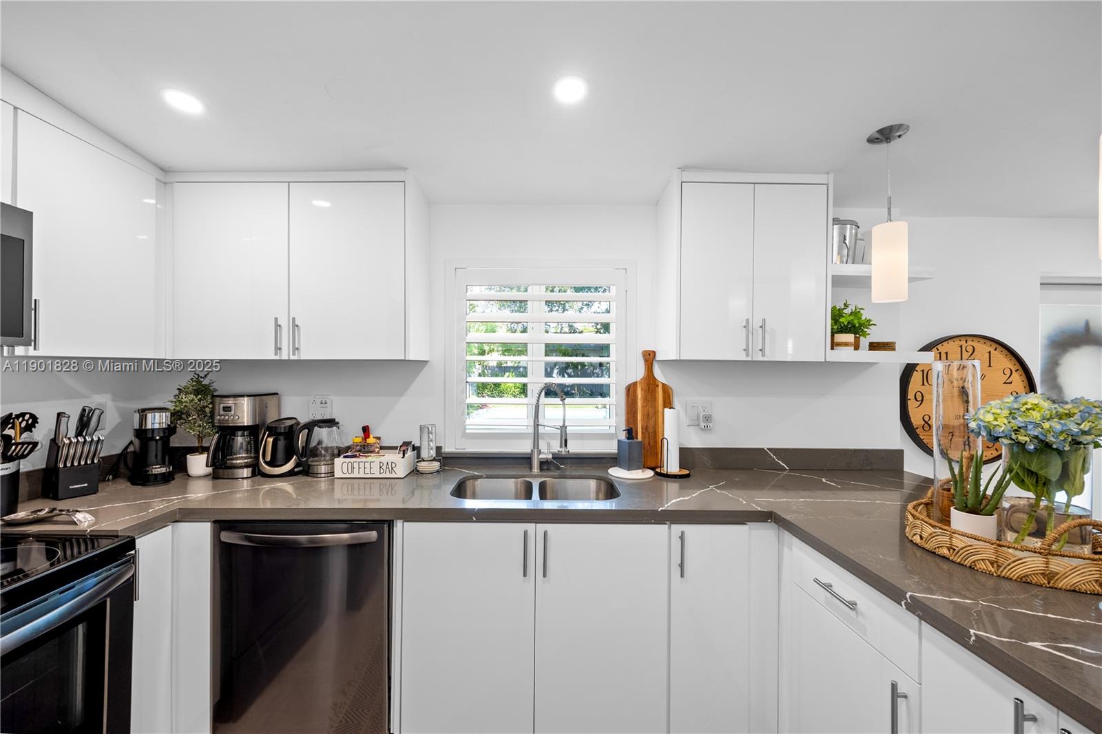 11 Northwest 45th Street Miami, FL 33127 - Photo 11 of 28 a kitchen with a sink a window and cabinets