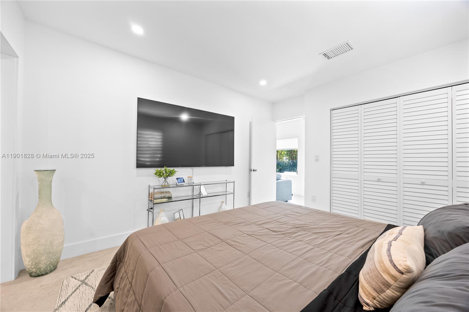 11 Northwest 45th Street Miami, FL 33127 - Photo 14 of 28 a bedroom with a bed and a flat screen tv