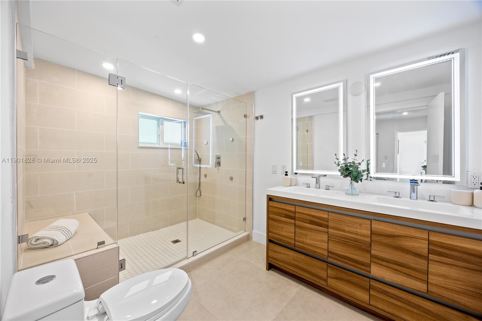 11 Northwest 45th Street Miami, FL 33127 - Photo 15 of 28 a bathroom with a double vanity sink toilet mirror and bathtub