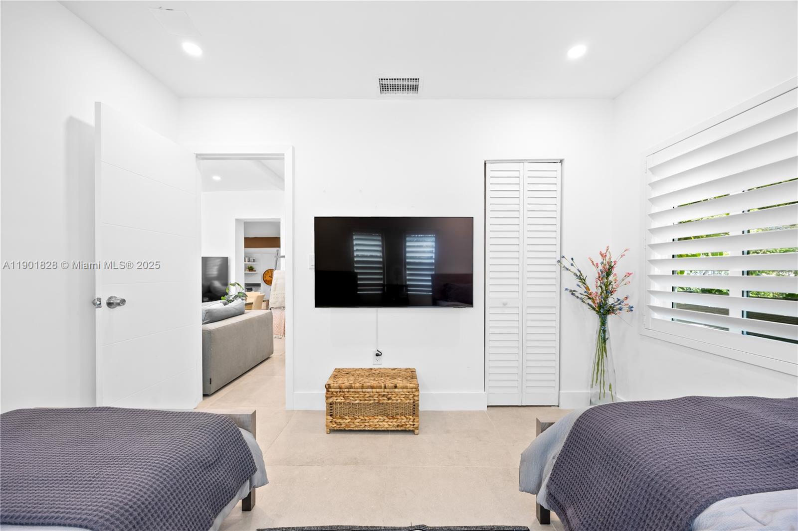 11 Northwest 45th Street Miami, FL 33127 - Photo 17 of 28 a living room with furniture and a flat screen tv